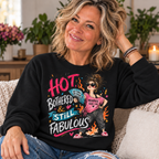 Black — blonde woman in her 50s wearing Hot Bothered and Still Fabulous sweatshirt